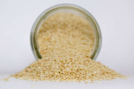 Glass jar with sesame isolated on white backgroundの写真素材