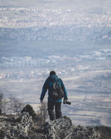 Photographer in action on Mountains with a nice Viewの写真素材