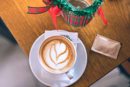 Coffee on Wooden table with Flower Decorationの写真素材