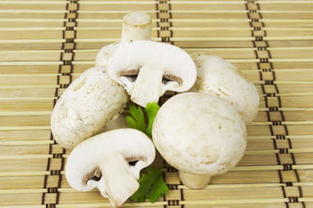 mushrooms champignon on a wooden tableの写真素材