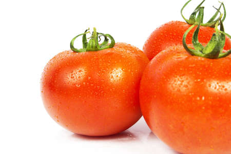 Three ripe tomato with drops isolated on white backgroundの写真素材