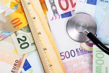 Ruler and stethoscope on money bills backgroundの写真素材