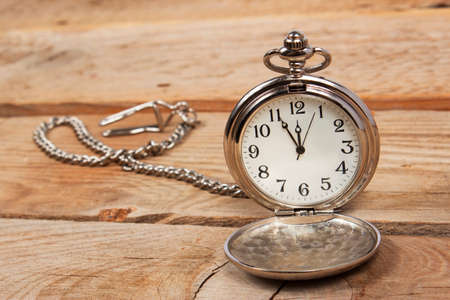 Vintage pocket watch on a wooden background