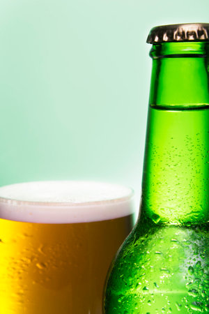 Close up of a beer bottle and a glass full of beerの写真素材
