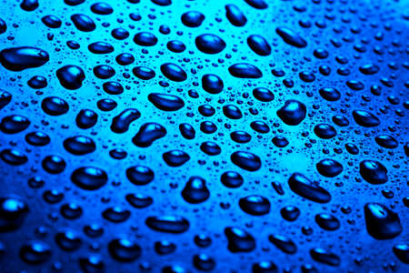 Water drops on blue surfaceの写真素材