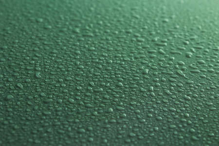 Water drops on green surfaceの写真素材