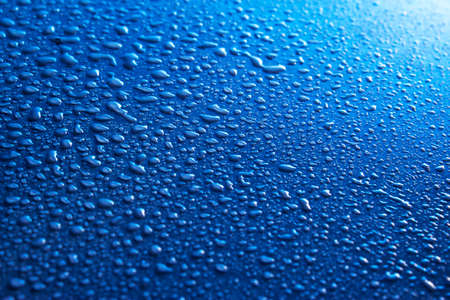 Water drops on blue surfaceの写真素材