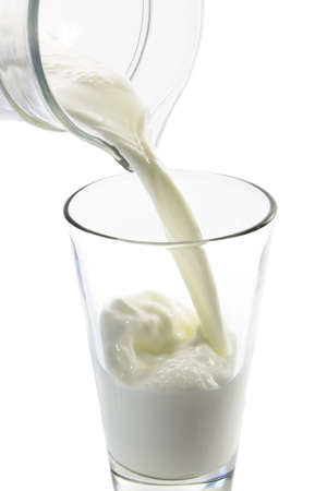 Close up of milk being pored in a glassの写真素材