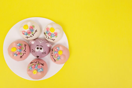 the cakes on a white plate, yellow background