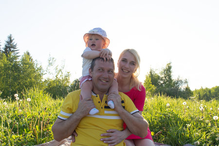 the Happy family with a child in natureの写真素材