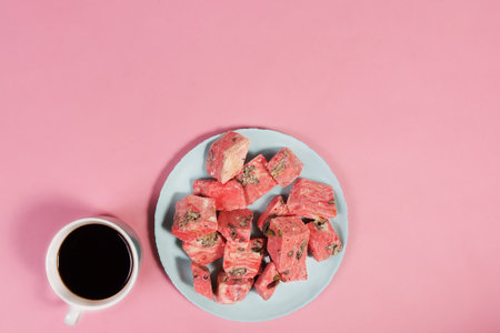the coffee and sweet dessert on a pink background, top view