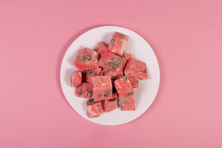 sweet dessert on a plate on a rose background, view from aboveの写真素材