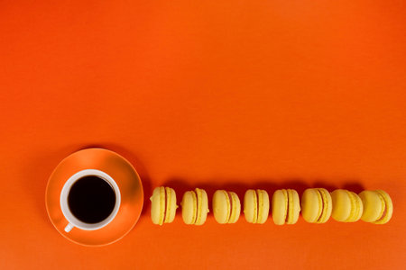 the coffee and yellow cookies on an orange background, layoutの写真素材