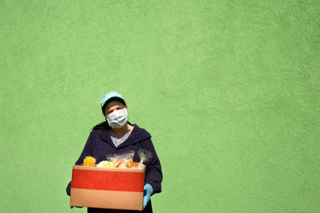 the women with a box of food, help and donation of food