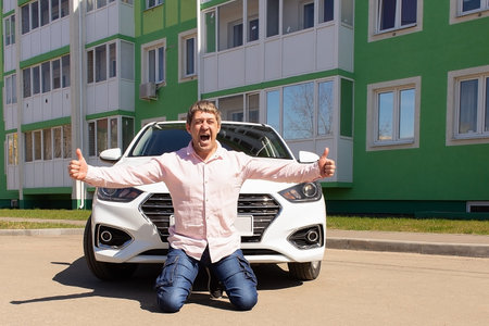 the Happy man rejoices in the new carの写真素材