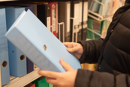 the Blue paper folder in hand