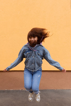 the Happy girl in denim jumps