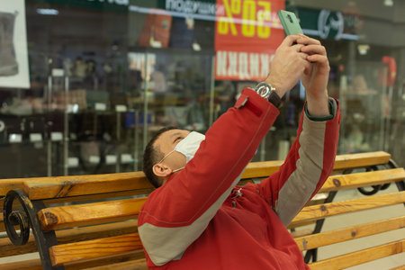 the Happy man on a bench with a phone