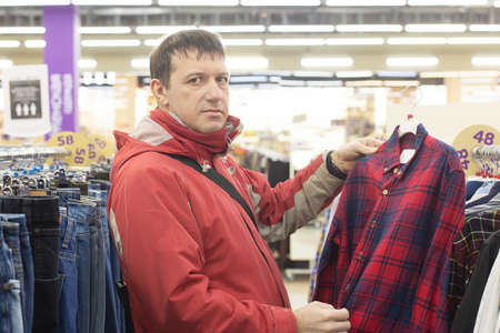 man in the store chooses a shirt, knitwearの写真素材
