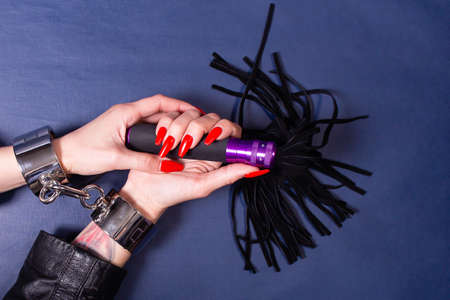 the hands in handcuffs with whip, BDSM theme