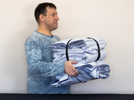 Textile industry, clothing production, man with fabric knitwearの写真素材