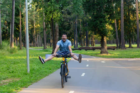 the Strong man on a bike in the parkの写真素材