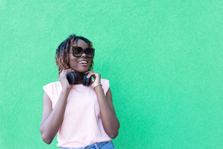 the beautiful African American woman in headphones on the streetの写真素材