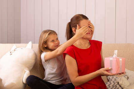 the Happy daughter gives her mother a giftの写真素材