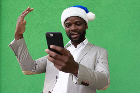 the African-American in a New Year's hat with a phone