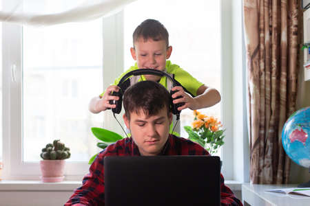 the Schoolchildren at home listen to musicの写真素材
