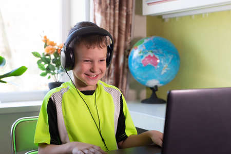 the Happy child with headphones at home
