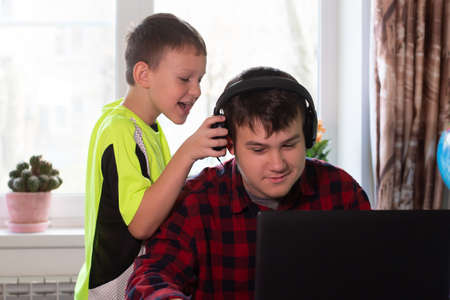 the Schoolchildren at home listen to musicの写真素材
