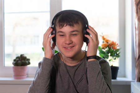 the Happy schoolboy at home, headphonesの写真素材