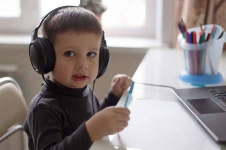 the Happy little boy at home, headphonesの写真素材