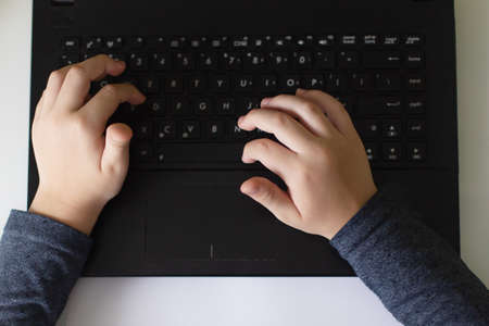 the Baby hands on a black keyboardの写真素材