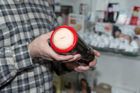 Toys for adults in men's hands, the concept of a sex shop.の写真素材