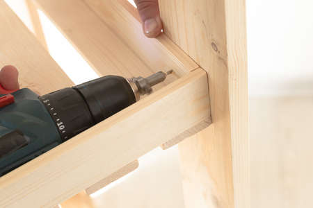 Wooden slats and working tools. Carpentry work. Working with power tools.