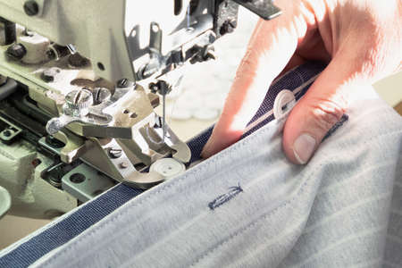 Textile industry, clothing production. Close-up of sewing equipment. Loops and buttons.