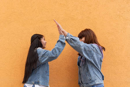 the Happy young girls give five to each otherの写真素材