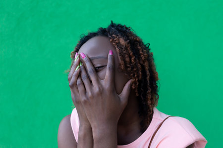 African American covered her face with her hand, portraitの写真素材