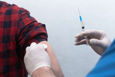 Human vaccination, close-up. Syringe in hand. Lifestyle.の写真素材