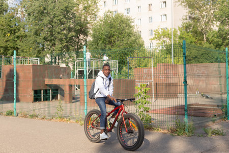 A happy man rides a bicycle through a public park. sports and recreation.の写真素材