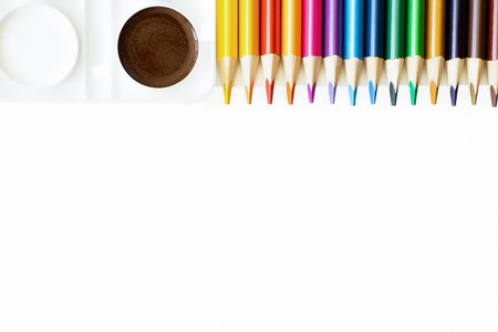 Colored pencils and paints on a white background. back to school. copyspace.の写真素材
