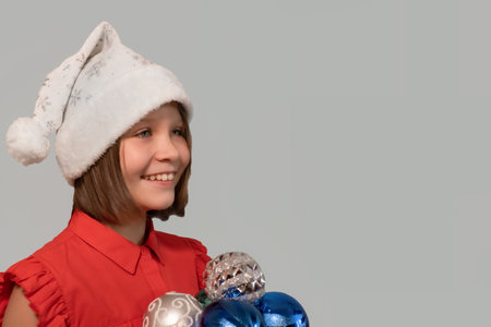 A smiling girl in a Christmas hat. copyspace. holidays and events.の写真素材