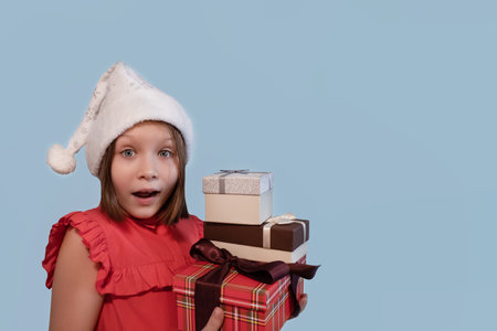 A smiling girl with a Christmas present. holidays and events. Christmas. copyspace.の写真素材