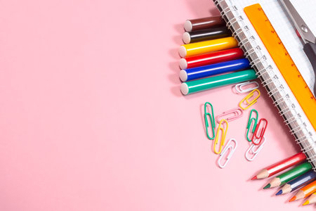 Colored pencils and markers on a pink background. back to school. copyspace.の写真素材
