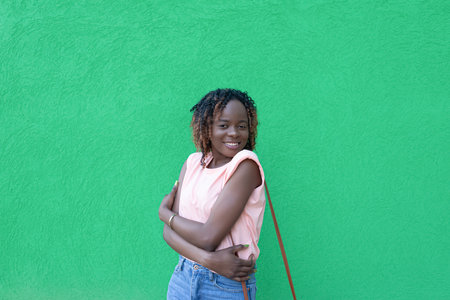 Smiling happy woman on a green background. Romance. positive emotions.の写真素材