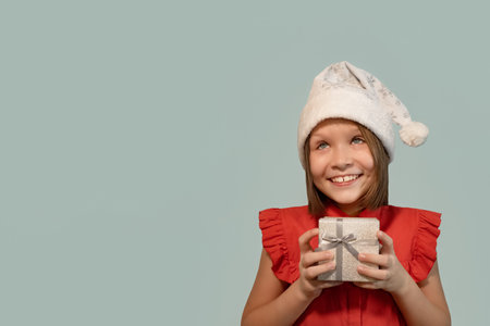 A smiling girl with a gift box in her hands. holidays and events. copyspace.の写真素材