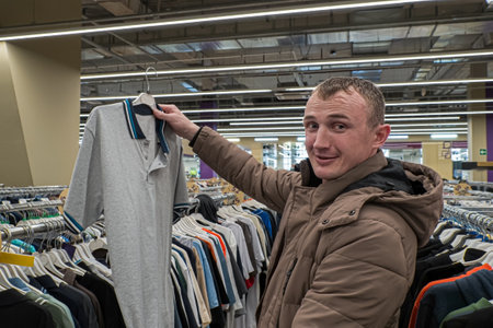 A man chooses casual clothing. T-shirts. Textile industry. Clothing stores.の写真素材