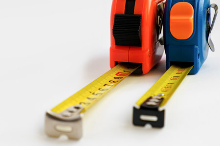 The measuring device is a meter. A construction tool on a white background. The construction...